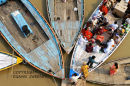 Pilgrims  returning from a dawn boat trip on the Ganges river at Varanassi . India