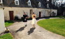 Nicky Heraty is escorted to Traquair House chapel by Bruce the Piper