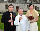 Joe & Nicky Mulchrone enjoy a drink with Father John after their wedding ceremony