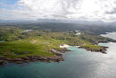 Aerial view of Clachtoll caravan park and surrounding Assynt mountains